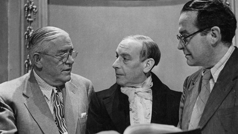 American film censor Joseph Breen, actor Sir Cedric Hardwicke, and director Alberto Cavalcanti discuss the script for a film version of the Charles Dickens novel The Life and Adventures of Nicholas Nickleby at Ealing Studios, London, July 1946. The film was ultimately made with an altered ending for the American market, since the Hays Code required that a character to be shown as insane if they are to commit suicide.